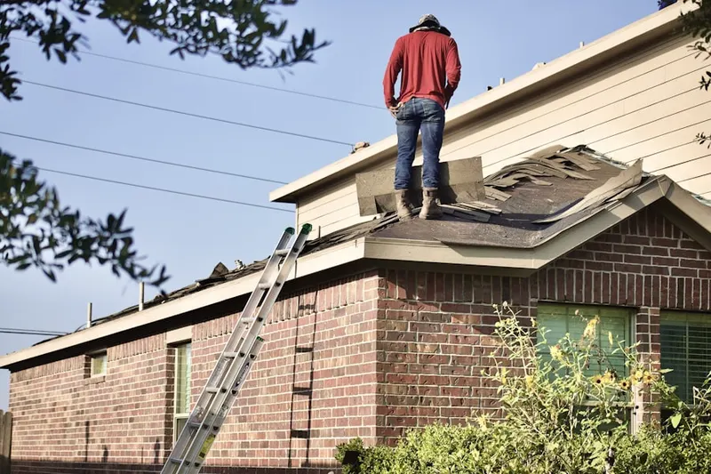 Professional roofer working on a residential roof in North Heights